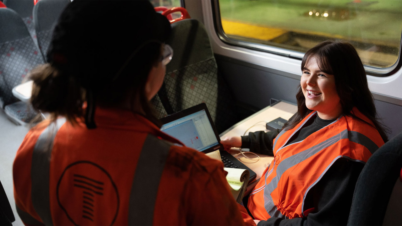 Two colleagues working on a train in the depot