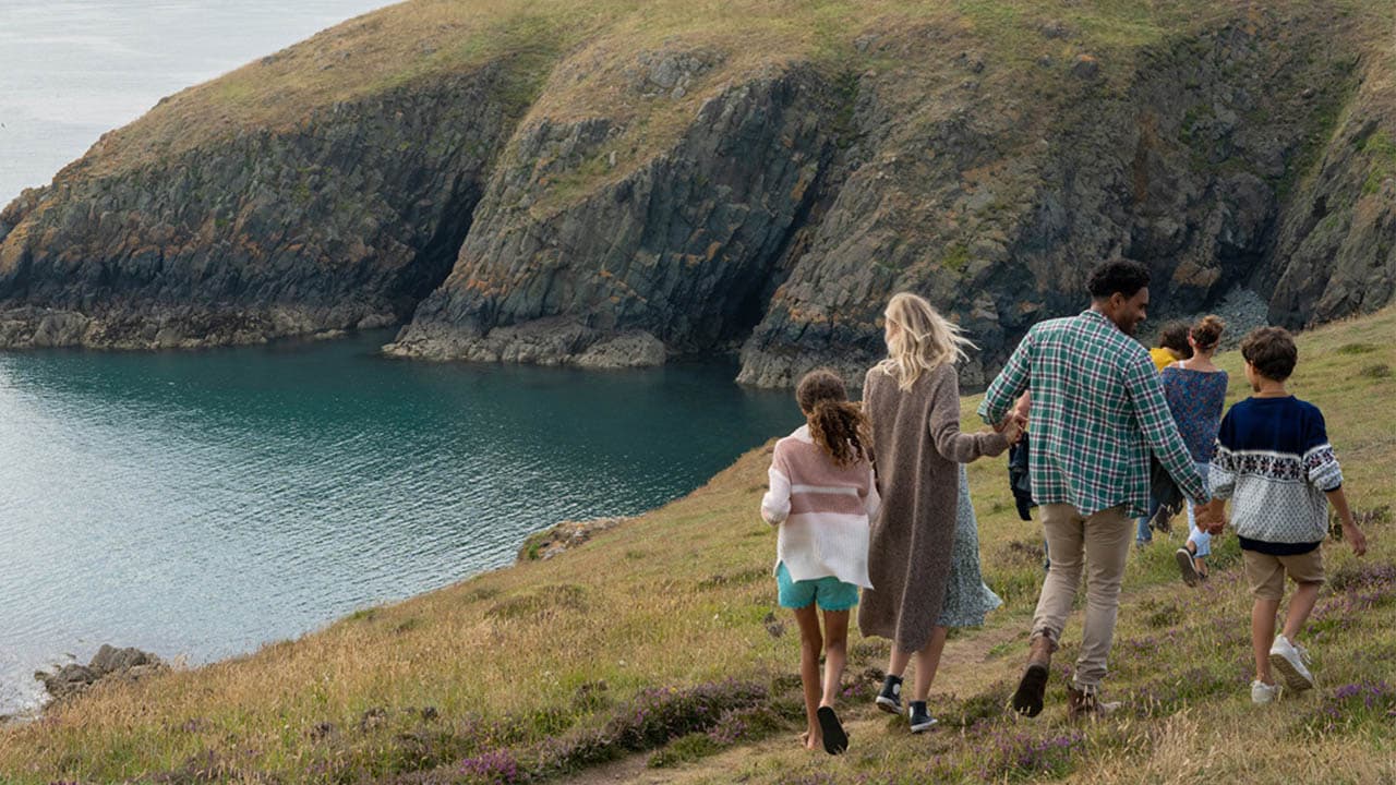 Family walking by the coast