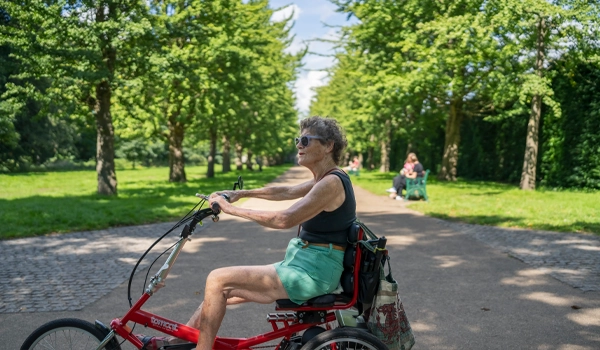Woman cycling tricycle.